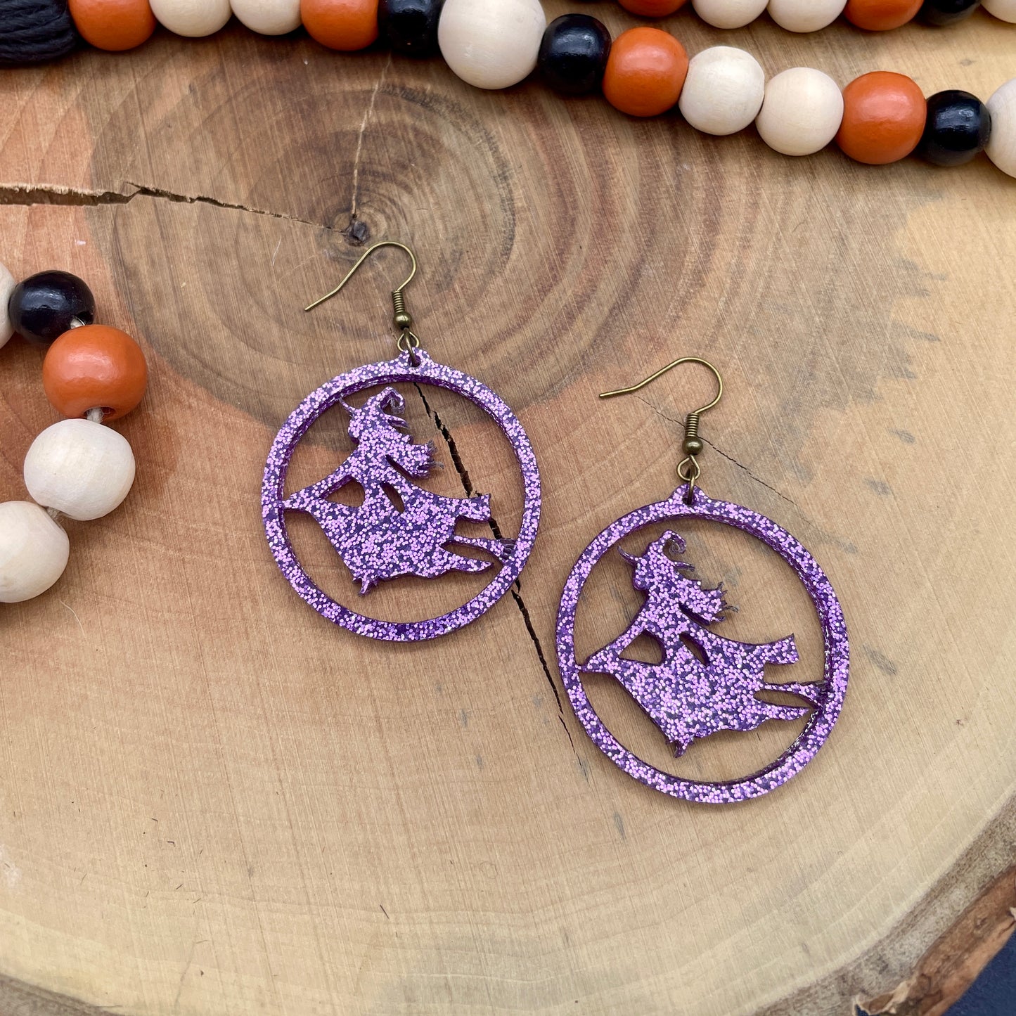 Witch on a broom Halloween earrings