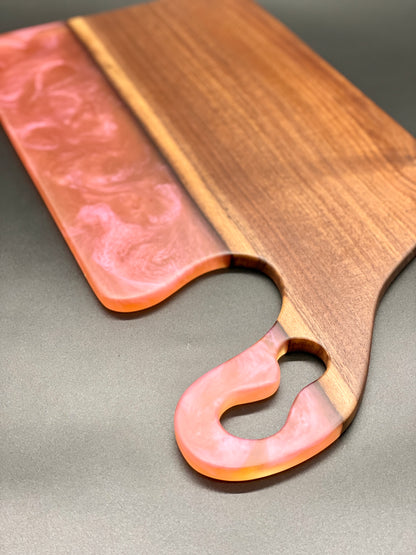 Walnut board with translucent pink resin