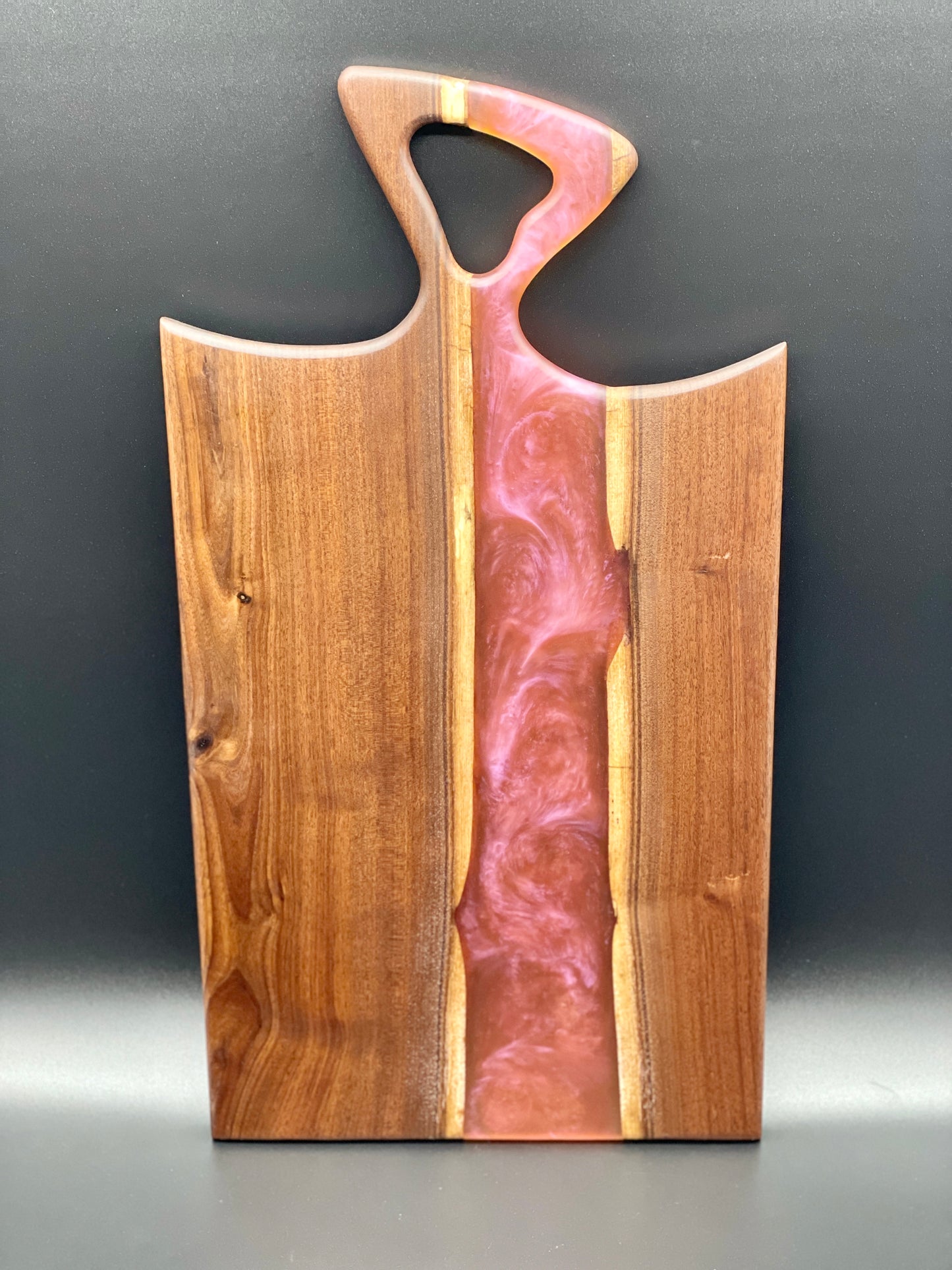Walnut board with translucent pink resin