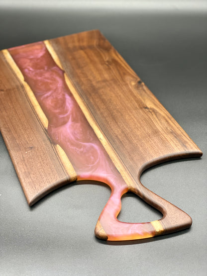 Walnut board with translucent pink resin