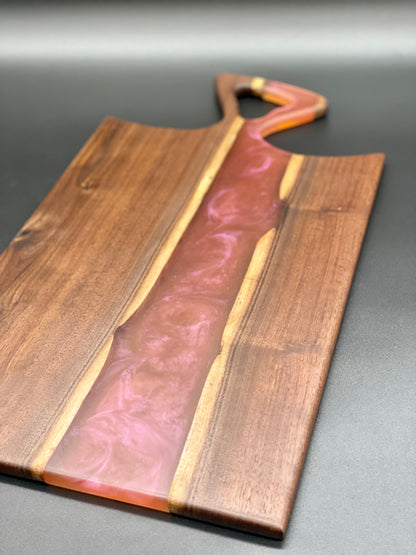 Walnut board with translucent pink resin